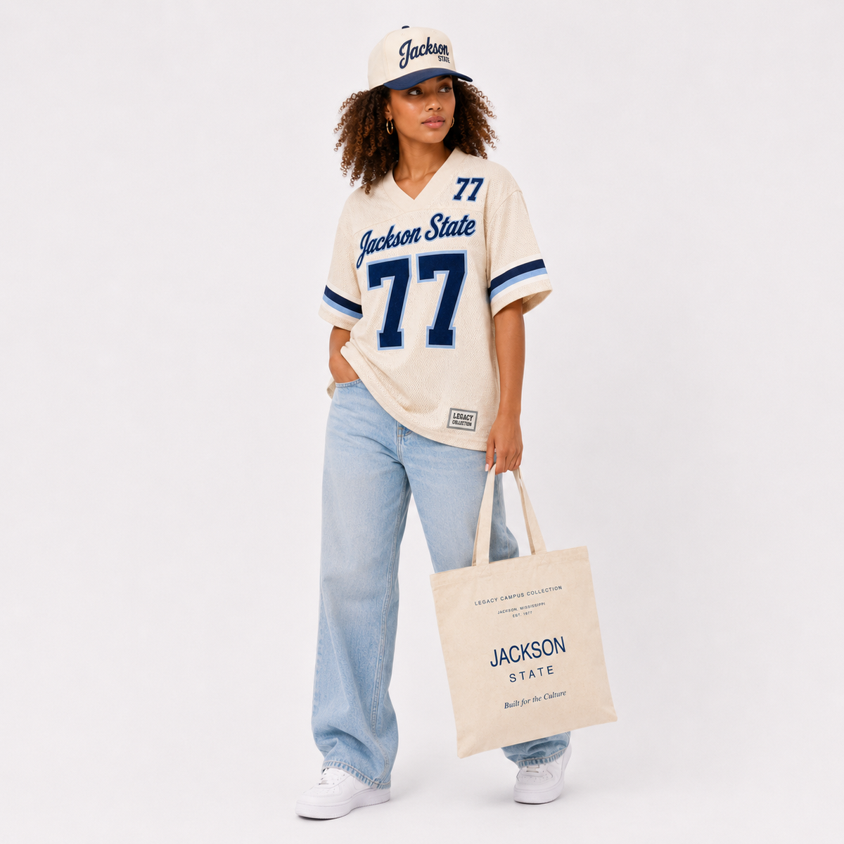 Jackson State Legacy Campus Collection female campaign model in cream jersey with cap and tote